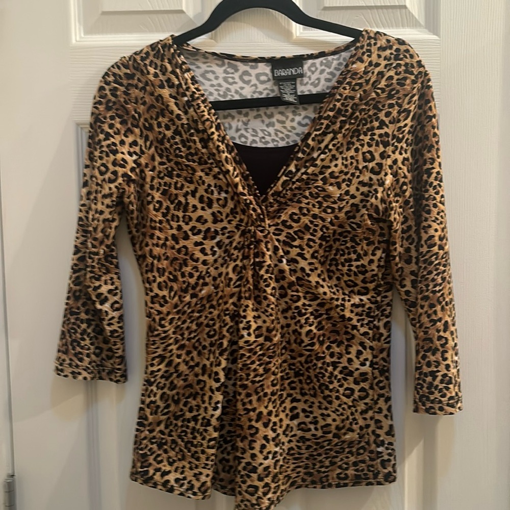 Leopard print twist top with built in black tank. Women’s size Medium